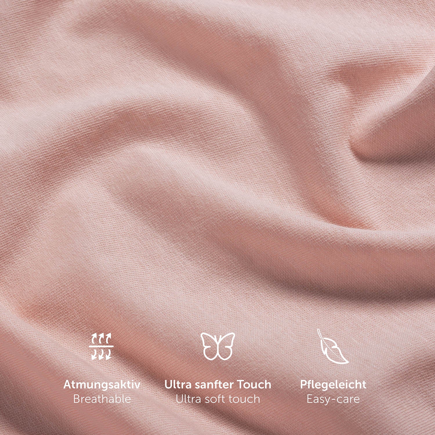 Nahaufnahme der Textur eines rosefarbenen Spannbettlakens mit Symbolen für Atmungsaktivität ultra weichen Touch und Pflegeleichtigkeit.